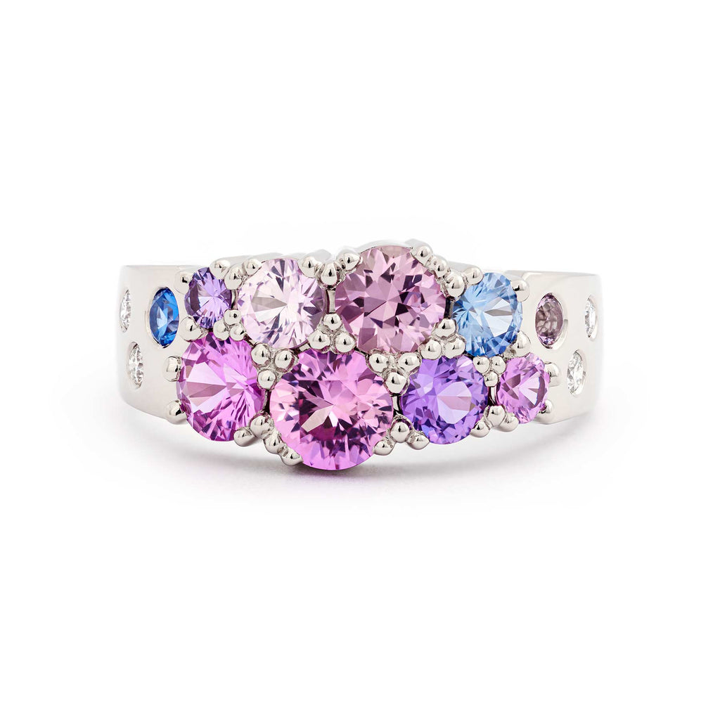 Narrowing Keto Meadow ring in 18K white gold with different size pink, violet and blue sapphires and white tw/vs diamonds. Design by Jussi Louesalmi, Au3 Goldsmiths.
