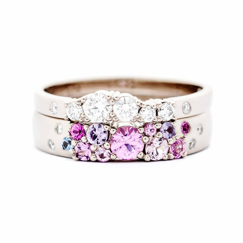 4mm wide Keto Meadow ring with pink, purple and blue sapphires and white diamonds together with 2mm wide Keto Meadow ring with white diamonds. Both rings are made in 750 white gold. Design by Jussi Louesalmi, Au3 Goldsmiths.