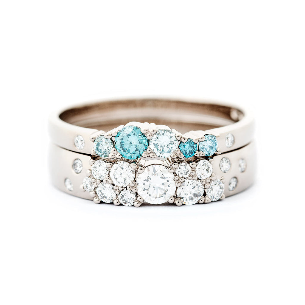 4mm wide Keto Meadow ring with white tw/vs diamonds combined with 2mm wide Keto Meadow ring with turquoise and white diamonds. Both rings are made in 750 white gold. Design by Jussi Louesalmi, Au3 Goldsmiths.