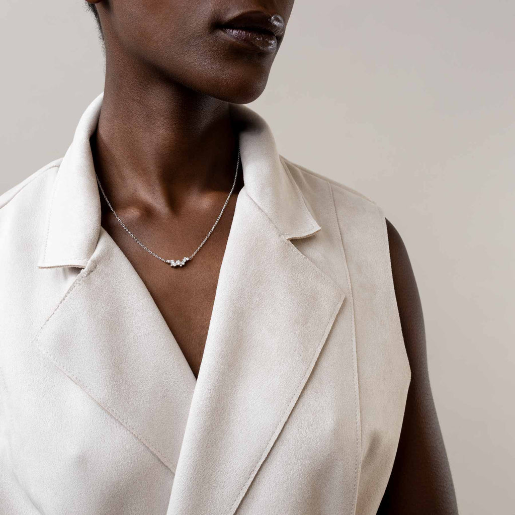 Keto Meadow diamond necklace on a female model. The necklace is designed by Jussi Louesalmi, Au3 Goldsmiths.