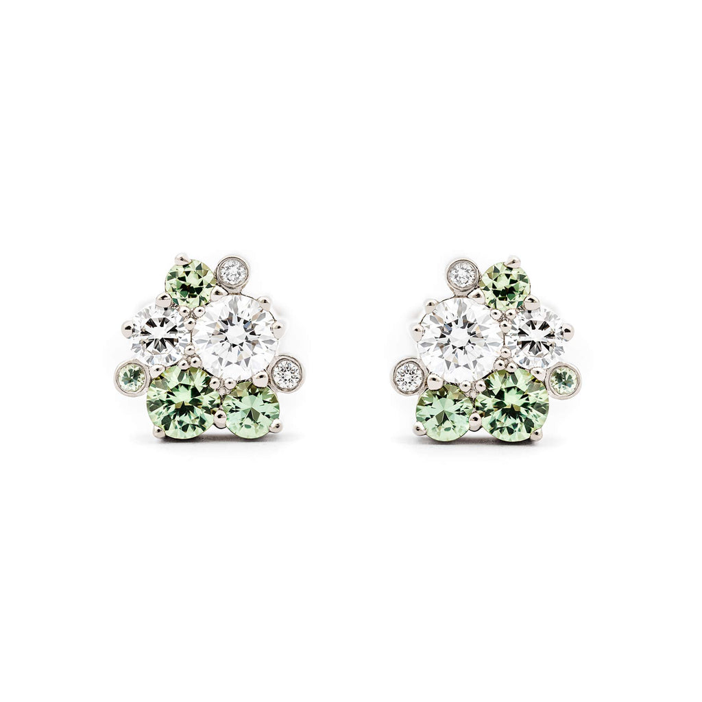 Different size pastel green sapphires and white diamonds in Keto Meadow Spring collection's stud earrings, design by Jussi Louesalmi, Au3 Goldsmiths.
