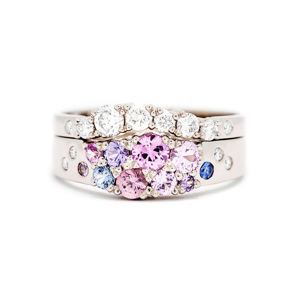 Combination of the Keto Meadow narrowing ring with pink, blue and violet sapphires and white diamonds and the Keto Meadow Arc ring with white diamonds. Design by Jussi Louesalmi, Au3 Goldsmiths.