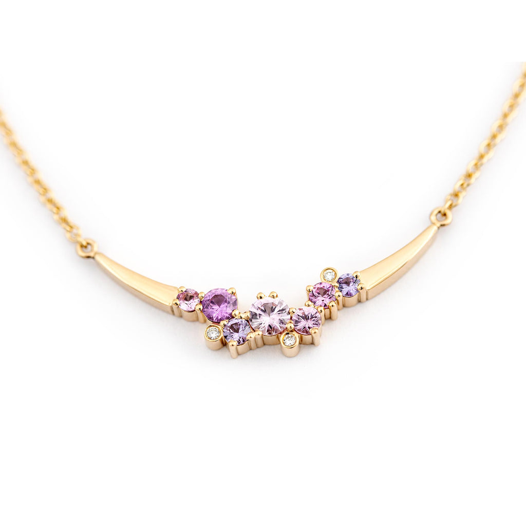 Keto Meadow Crown Arc necklace in 750 yellow gold. The necklace has 7 asymmetrically placed different size sapphires and 3 white diamonds. Design by Jussi Louesalmi, Au3 Goldsmiths.