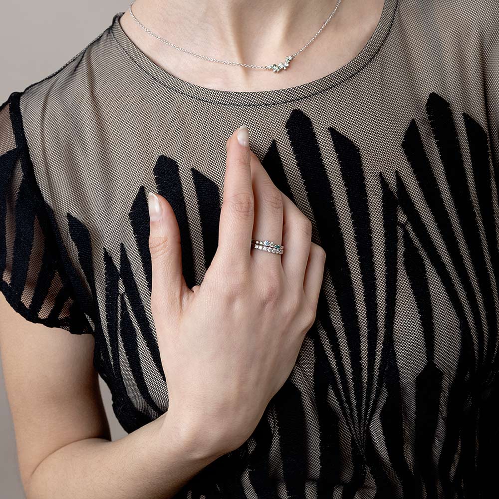 Model wearing rings and necklace.