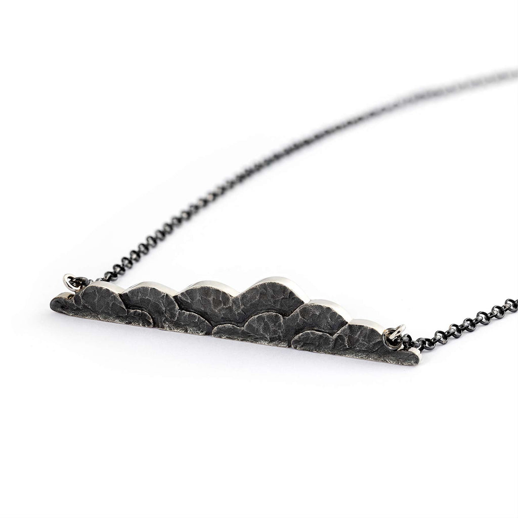 Organic shapes and dark surface in the Cloudy necklace by goldsmith Anu Kaartinen, Au3 Goldsmiths.