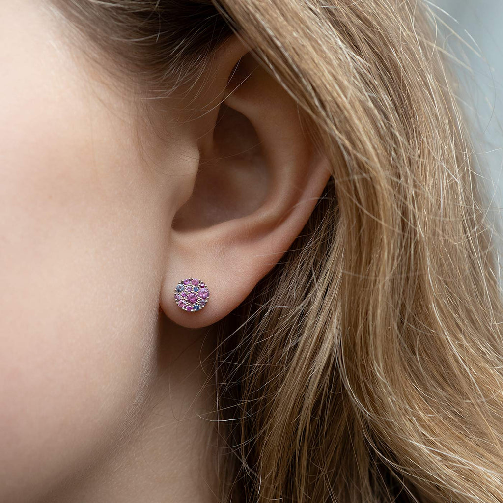 Model wearing a Cupcake earring made in 18K white gold with colorful sapphires. Design by Jussi Louesalmi, Au3 Goldsmiths.