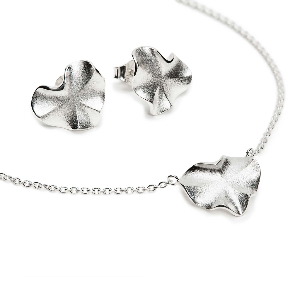 Organic shapes in a necklace and stud earrings made in 925 silver, design by Anu Kaartinen.