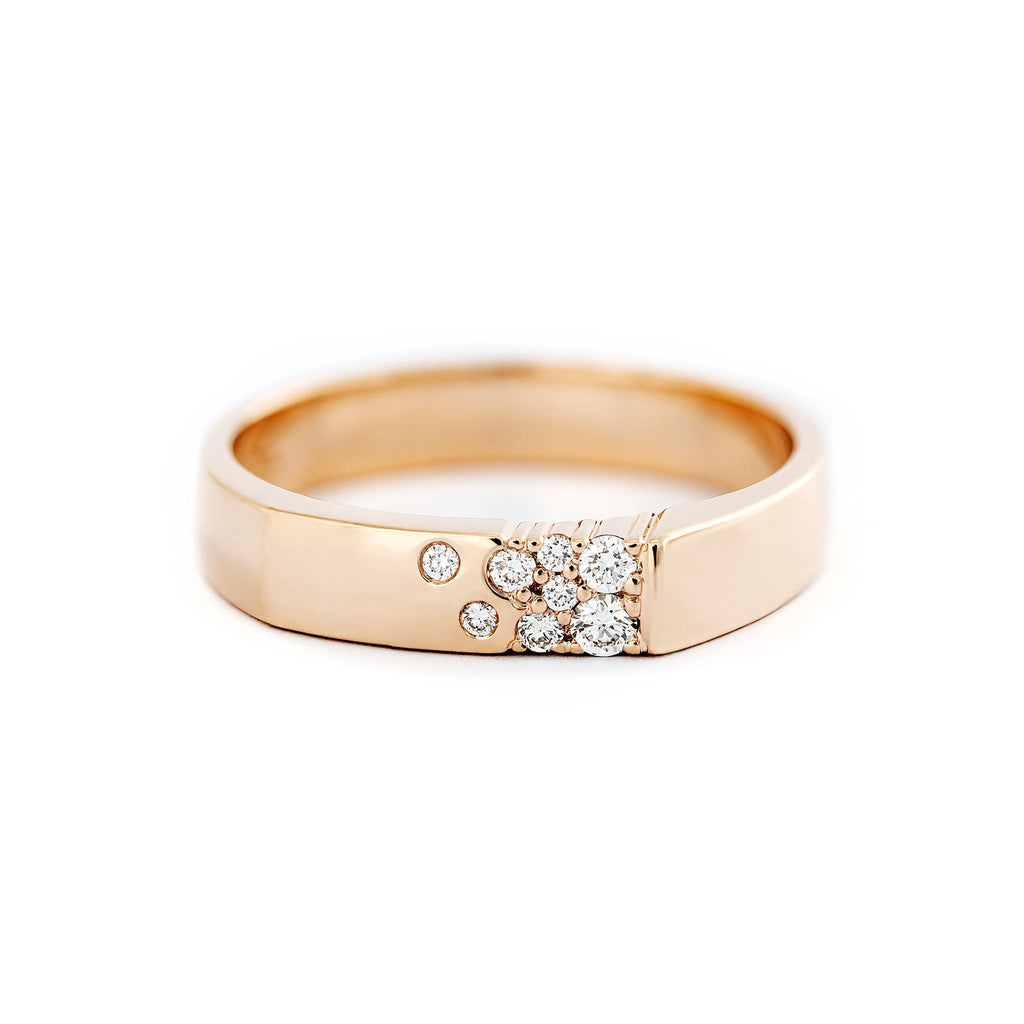 A sleek unisex Kero ring with multiple white diamonds set in a smooth band, available in different precious metals. Design by Jussi Louesalmi, Au3 Goldsmiths.