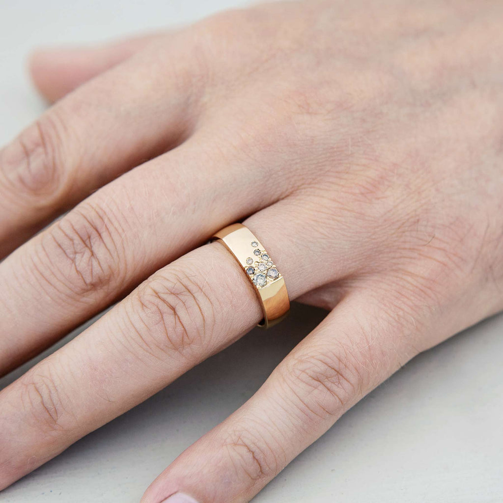 Model wearing a 6mm wide Kero ring made in 18K yellow gold, with brown diamonds. Design Jussi Louesalmi, Au3 Goldsmiths. 