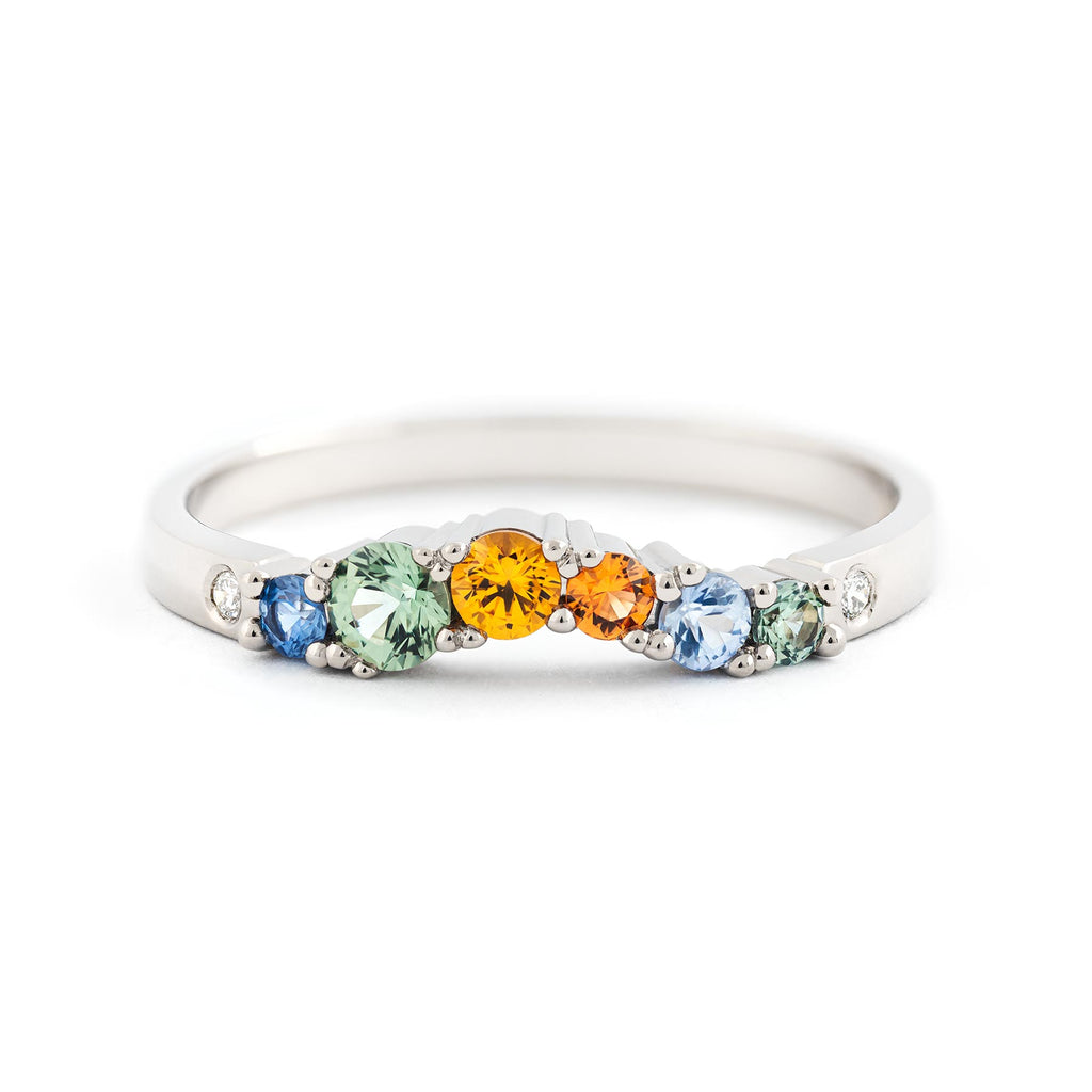 Vivid autumn colour sapphires and sparkling white diamonds in the Keto Meadow Arc Autumn ring crafted in 18K white gold. Design by Jussi Louesalmi, Au3 Goldsmiths.