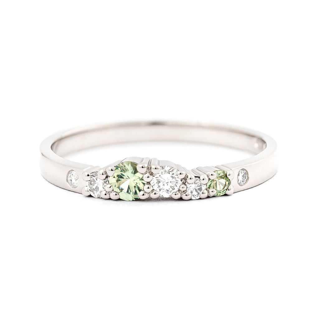 Pastel green diamonds and white diamonds in a 2mm wide Keto Meadow spring collections white gold ring. Design by Jussi Louesalmi, Au3 Goldsmiths.