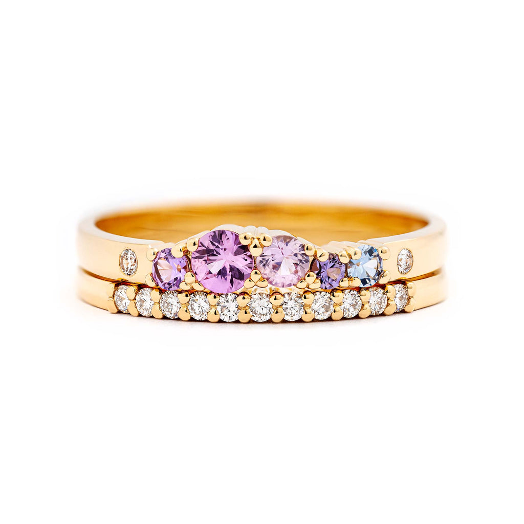 Keto Meadow ring with colorful sapphires and white diamonds combined with Raita 1,5mm wide row ring with white diamonds, both made in yellow gold. Design by Jussi Louesalmi, Au3 Goldsmiths.