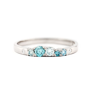 Vivid turquoise diamonds in a 2mm wide Keto Meadow ring, design by Jussi Louesalmi, Au3 Goldsmiths.