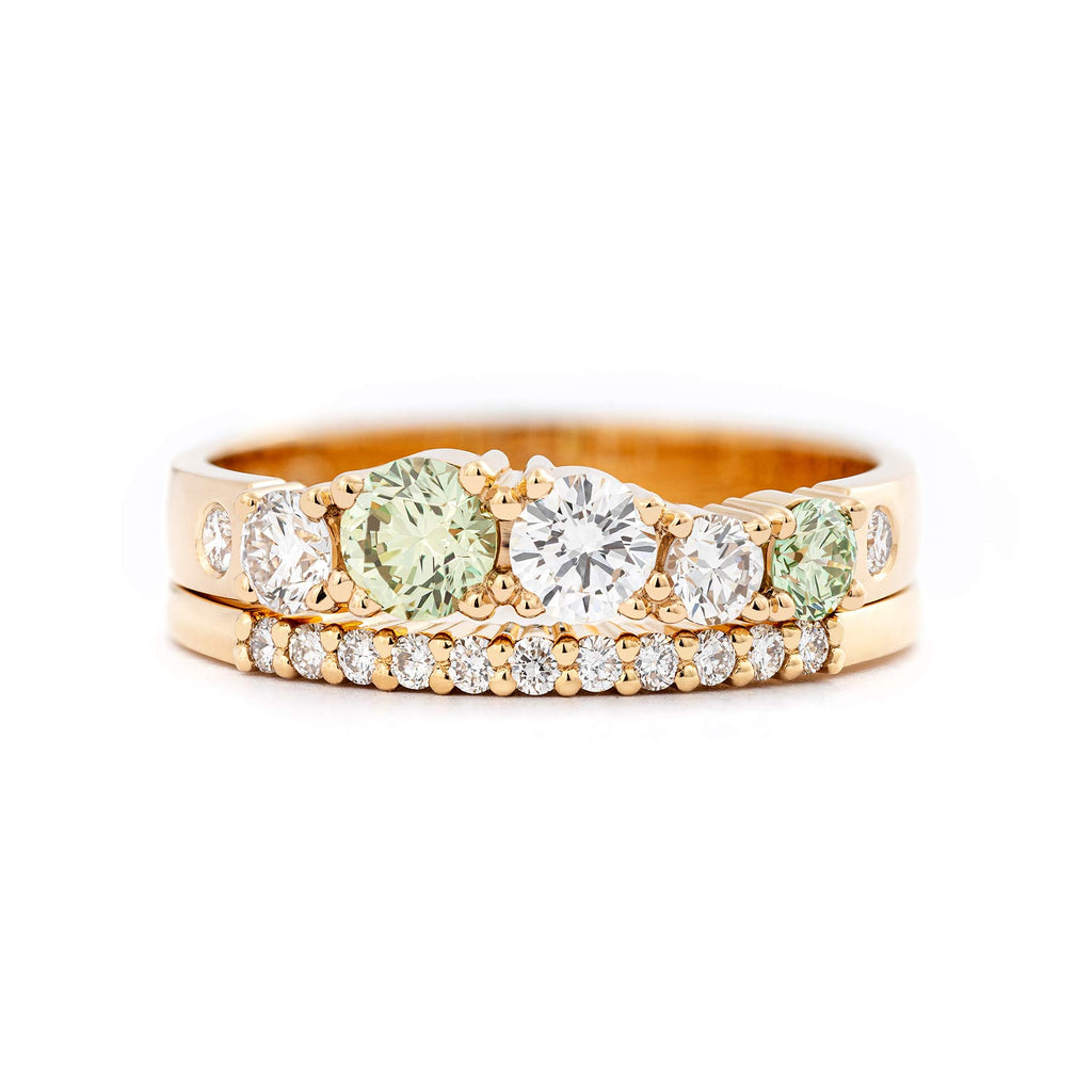 Keto Meadow Spring collection's 3mm wide ring with Pine Green diamonds and white diamonds, together with Raita 1.5mm ring with white diamonds. Design by Jussi Louesalmi, Au3 Goldsmiths