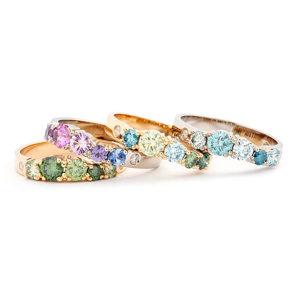 Colorful diamonds and sapphires in the piled Keto Meadow rings by goldsmith Jussi Louesalmi. 