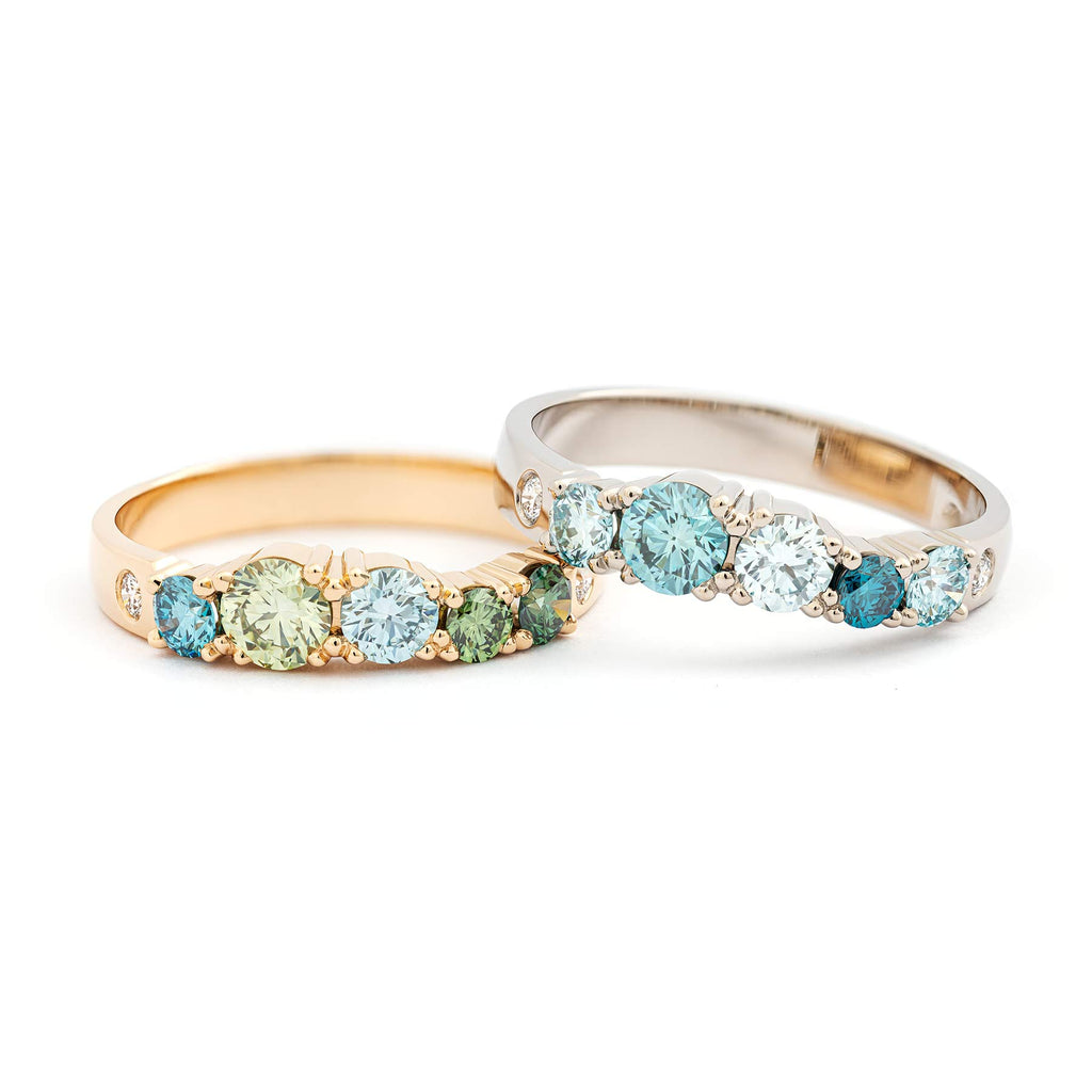 Colorful diamonds and white tw/vs diamonds in the 3mm wide Keto Meadow rings by goldsmith Jussi Louesalmi.
