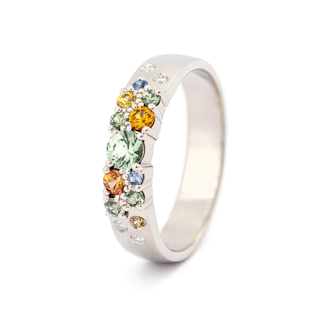 Different size green, orange, yellow and blue sapphires in the 4mm wide Keto Meadow diamond ring by goldsmith Jussi Louesalmi, Au3 Goldsmiths