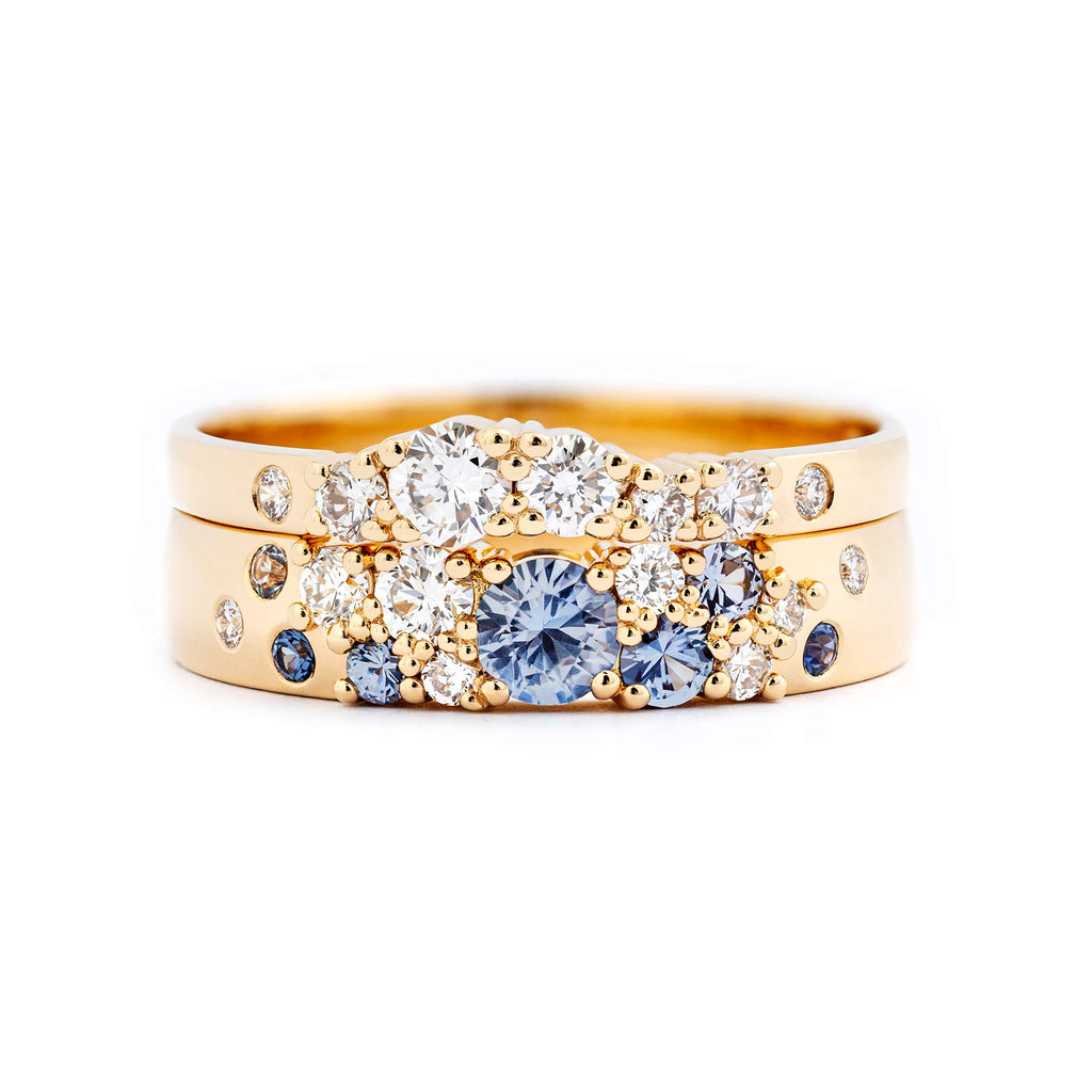 Keto Meadow Spring collection's 4mm wide ring with different size pastel blue sapphires and white tw/vs diamonds, together with 2mm wide Keto Meadow ring with white tw/vs diamonds, both rings made in 18K yellow gold. Design by Jussi Louesalmi, Au3 Goldsmiths.