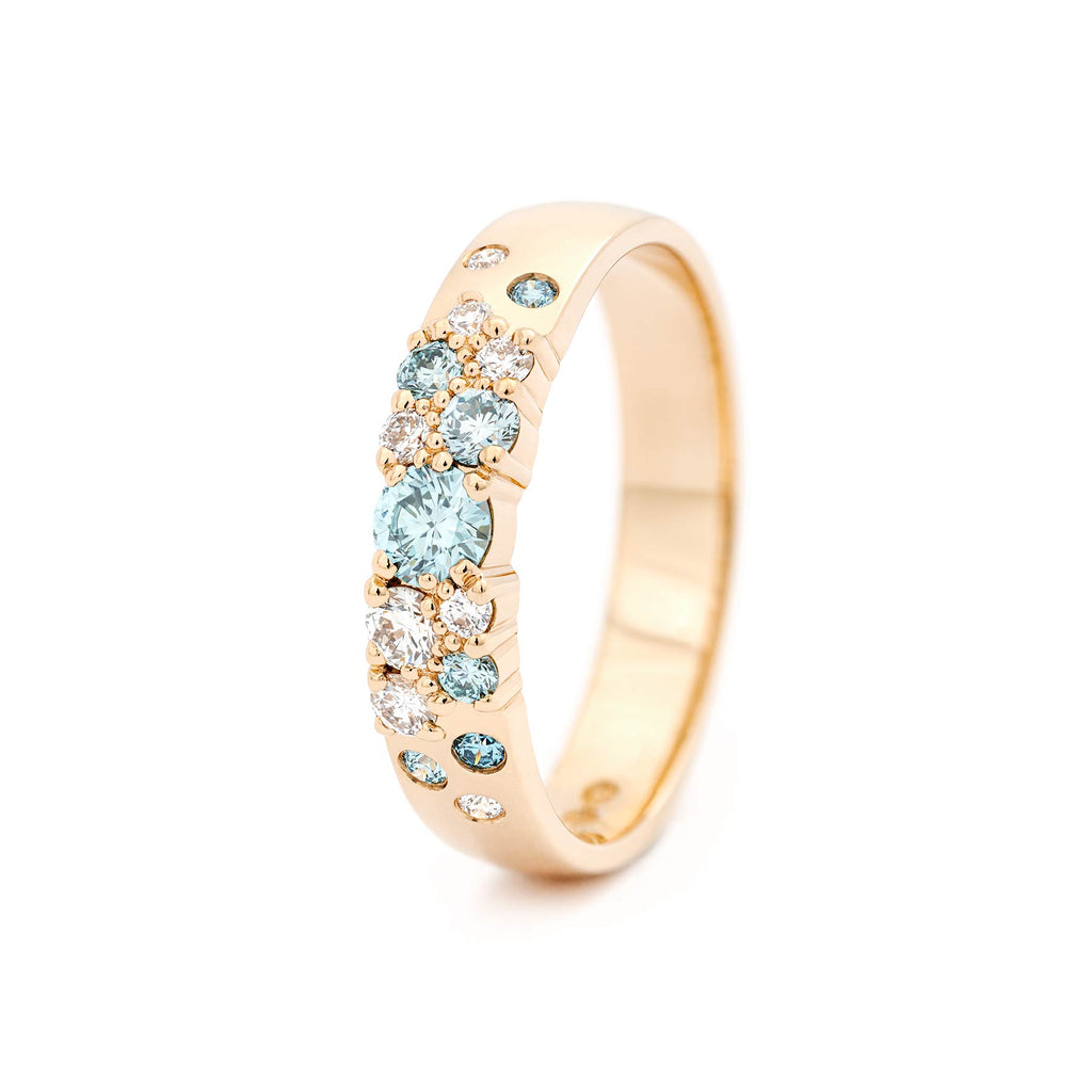 Keto Meadow 4mm wide ring in 18K yellow gold with turquoise Ice Blue diamonds and white diamonds. Design by Jussi Louesalmi, Au3 Goldsmiths.