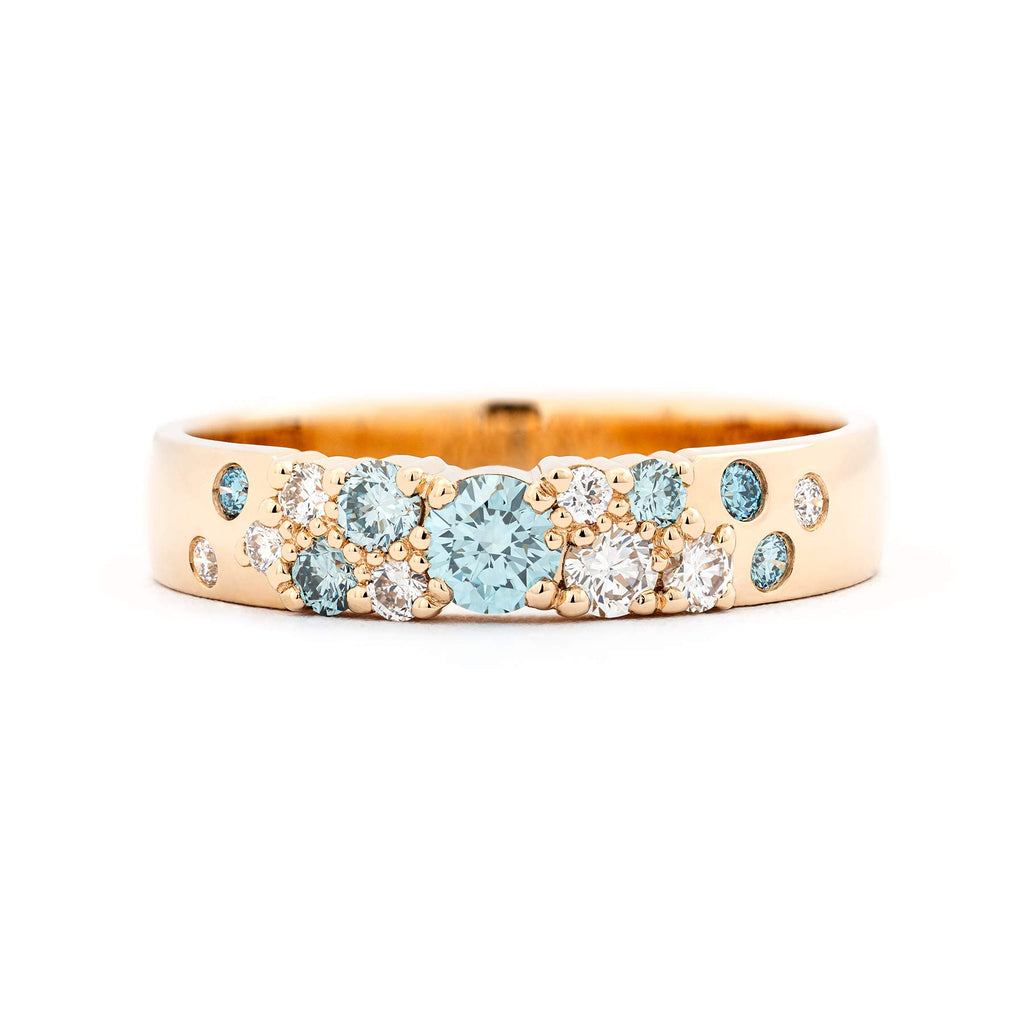 Keto Meadow 4mm wide ring in 18K yellow gold with asymmetrically placed turquoise Ice Blue diamonds and white diamonds. Design by Jussi Louesalmi, Au3 Goldsmiths.