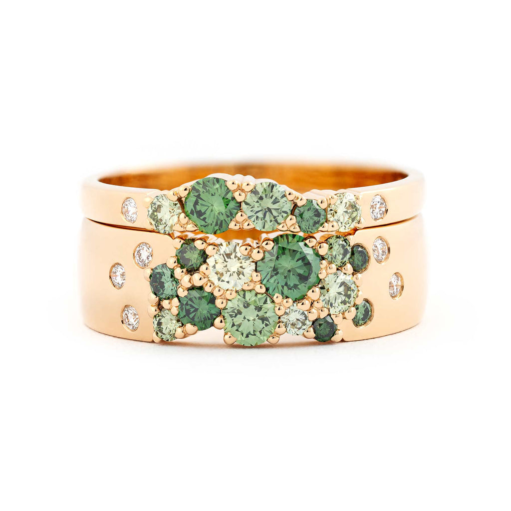 Green color diamonds and white diamonds in a combination of 6mm and 2mm wide rings crafted from 18K yellow gold. Design by Jussi Louesalmi, Au3 Goldsmiths.