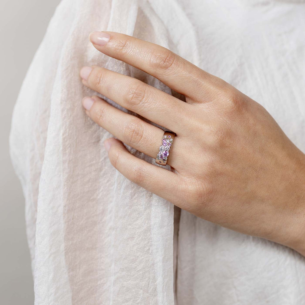 Model wearing a 6mm wide Keto Meadow Spring collections ring with pink sapphires and white diamonds. Design by Jussi Louesalmi, Au3 Goldsmiths. 