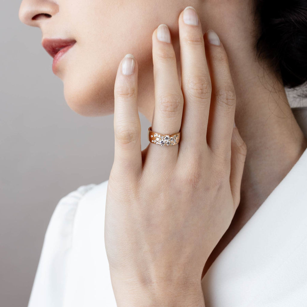 Model wearing 6mm wide Keto Meadow yellow gold ring with white diamonds. Design by Jussi Louesalmi, Au3 Goldsmiths.
