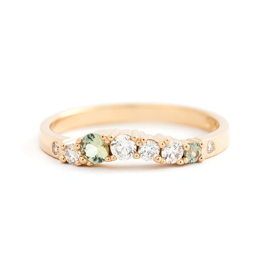 Contour model Keto Meadow 2mm Arc ring with light green sapphires and white tw/vs diamonds in a 18K yellow gold band. Design Jussi Louesalmi, Au3 Goldsmiths.
