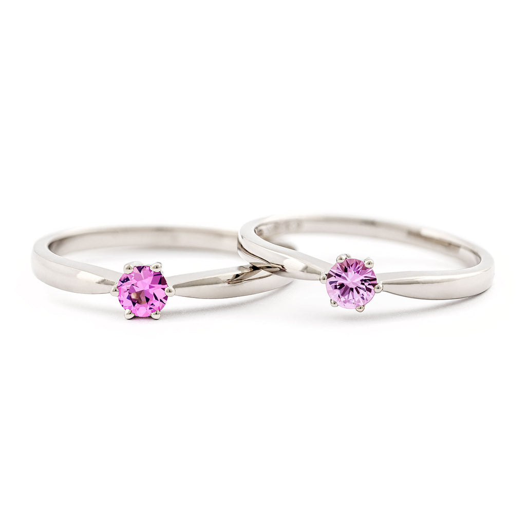 Two Keto Meadow solitaire rings side by side, one with pink sapphire, the other with light pink sapphire. Design by Jussi Louesalmi, Au3 Goldsmiths.