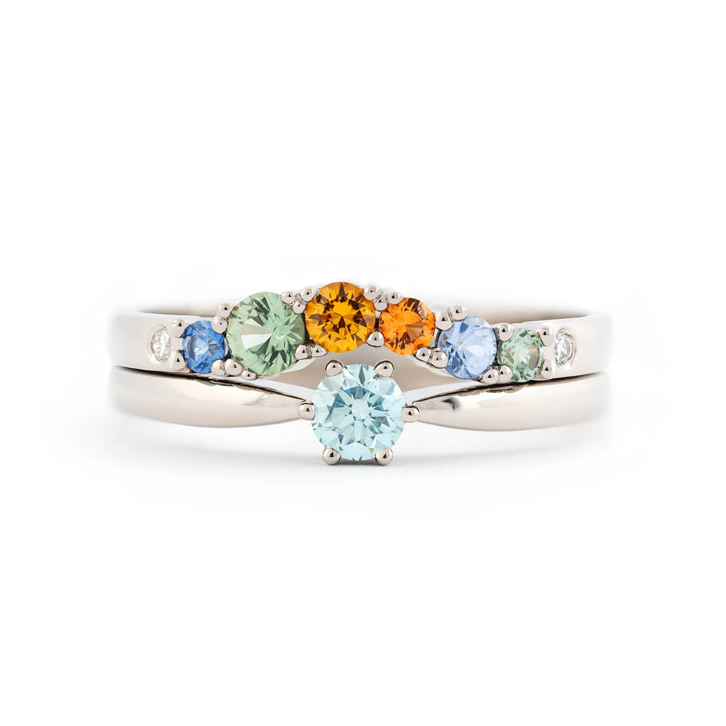 Keto Meadow One Ice Blue solitaire ring stacked with Keto Meadow Arc Autumn ring. Both rings are crafted in 18K white gold. Design by Jussi Louesalmi, Au3 Goldsmiths.
