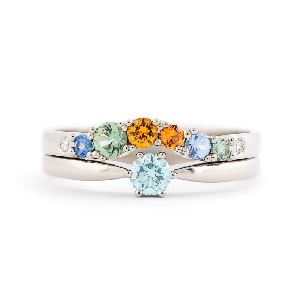 Keto Meadow One Ice Blue solitaire ring stacked with Keto Meadow Arc Autumn ring. Both rings are crafted in 18K white gold. Design by Jussi Louesalmi, Au3 Goldsmiths.