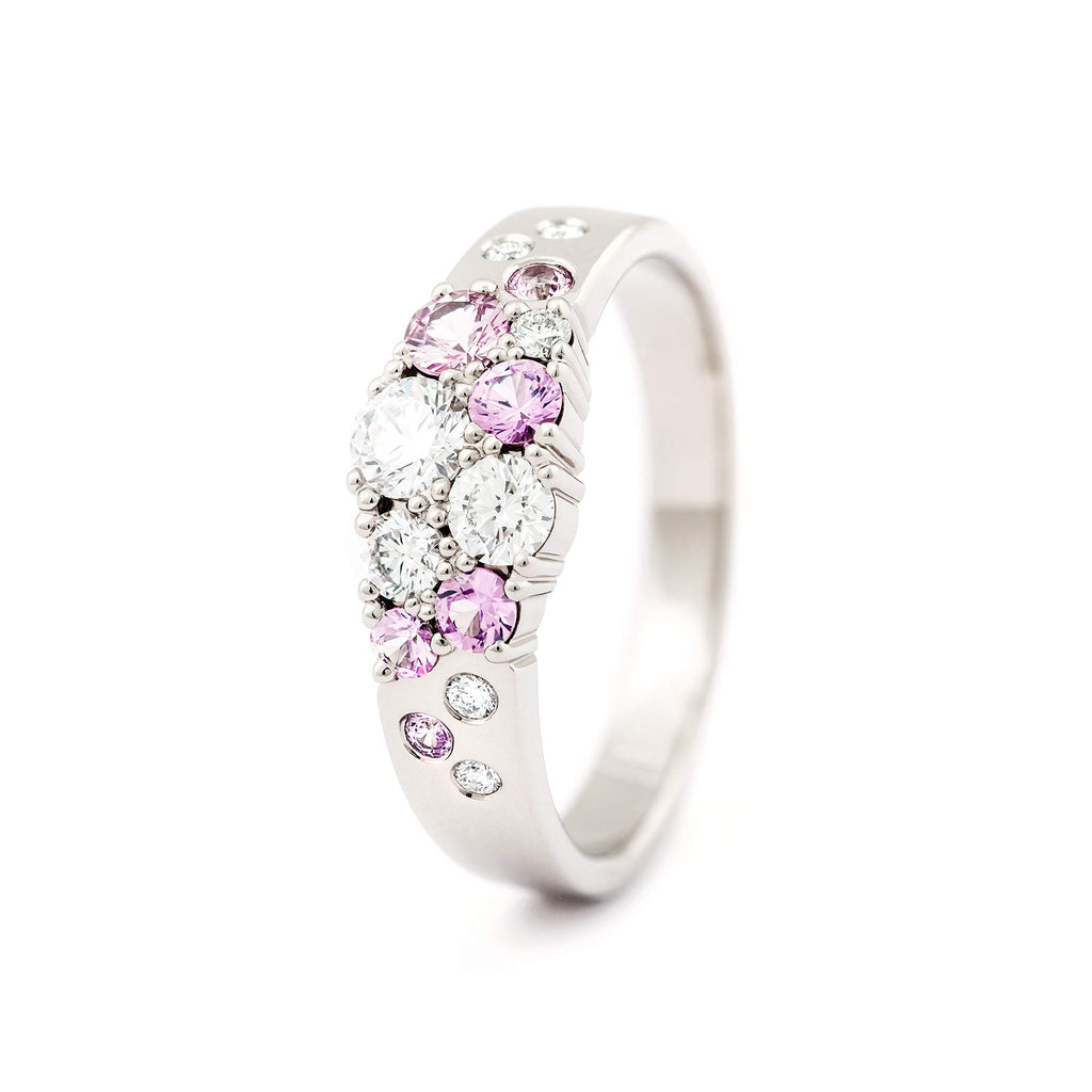 Different size light pink sapphires and white diamonds in the Keto Meadow narrowing ring, design by Jussi Louesalmi, Au3 Goldsmiths.