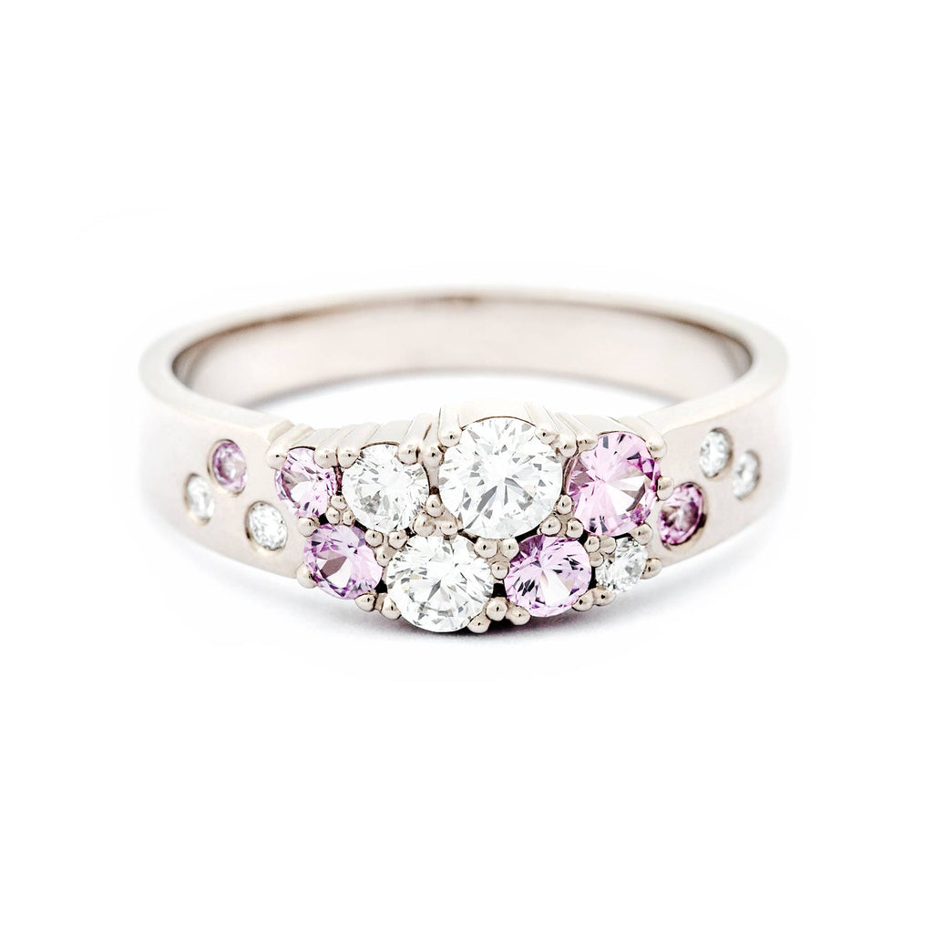 Different size light pink sapphires and white diamonds in the Keto Meadow narrowing ring, design by Jussi Louesalmi, Au3 Goldsmiths.