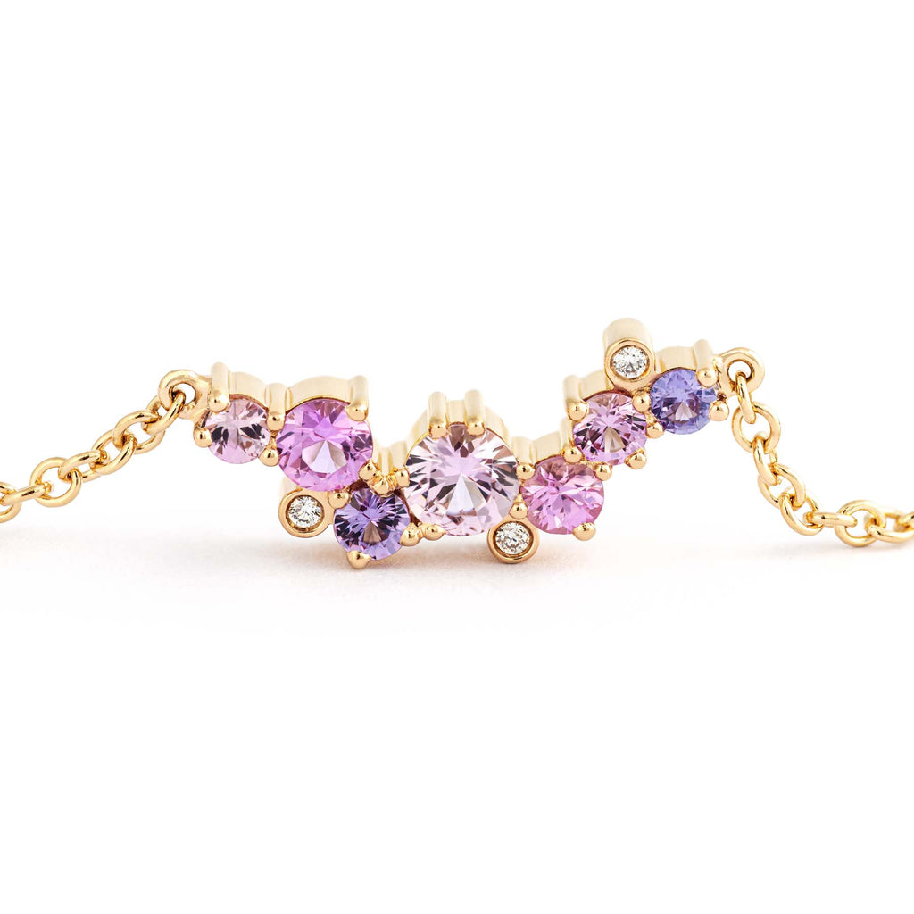 Asymmetrically placed different size colorful sapphires and white diamonds in a Keto Meadow Crown necklace made in 18K yellow gold, design by Jussi Louesalmi, Au3 Goldsmiths.