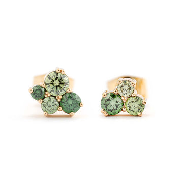 Treated color green diamonds in stud earrings crafted in 18K yellow gold. Design by Jussi Louesalmi, Au3 Goldsmiths.