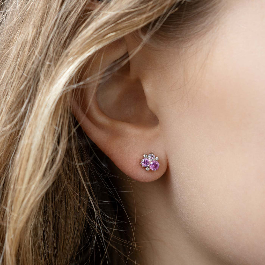 Model wearing a Keto Meadow earring made in 18K white gold with colorful sapphires and tw/vs diamonds. Design by Jussi Louesalmi, Au3 Goldsmiths.