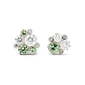 Different size light green sapphires and white tw/vs diamond in a pair of stud earrings, design by Jussi Louesalmi, Au3 Goldsmiths