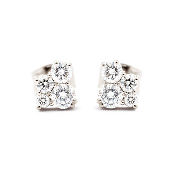 A pair of Keto Meadow stud earrings both with 4 white different size diamonds. Design by Jussi Louesalmi, Au3 Goldsmiths.