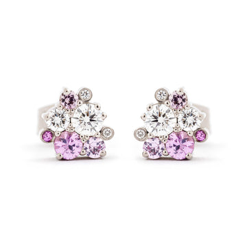 Stud earrings with different size pink sapphires and white tw/vs diamond placed asymmetrically in a cluster. Design by Jussi Louesalmi, Au3 Goldsmiths.
