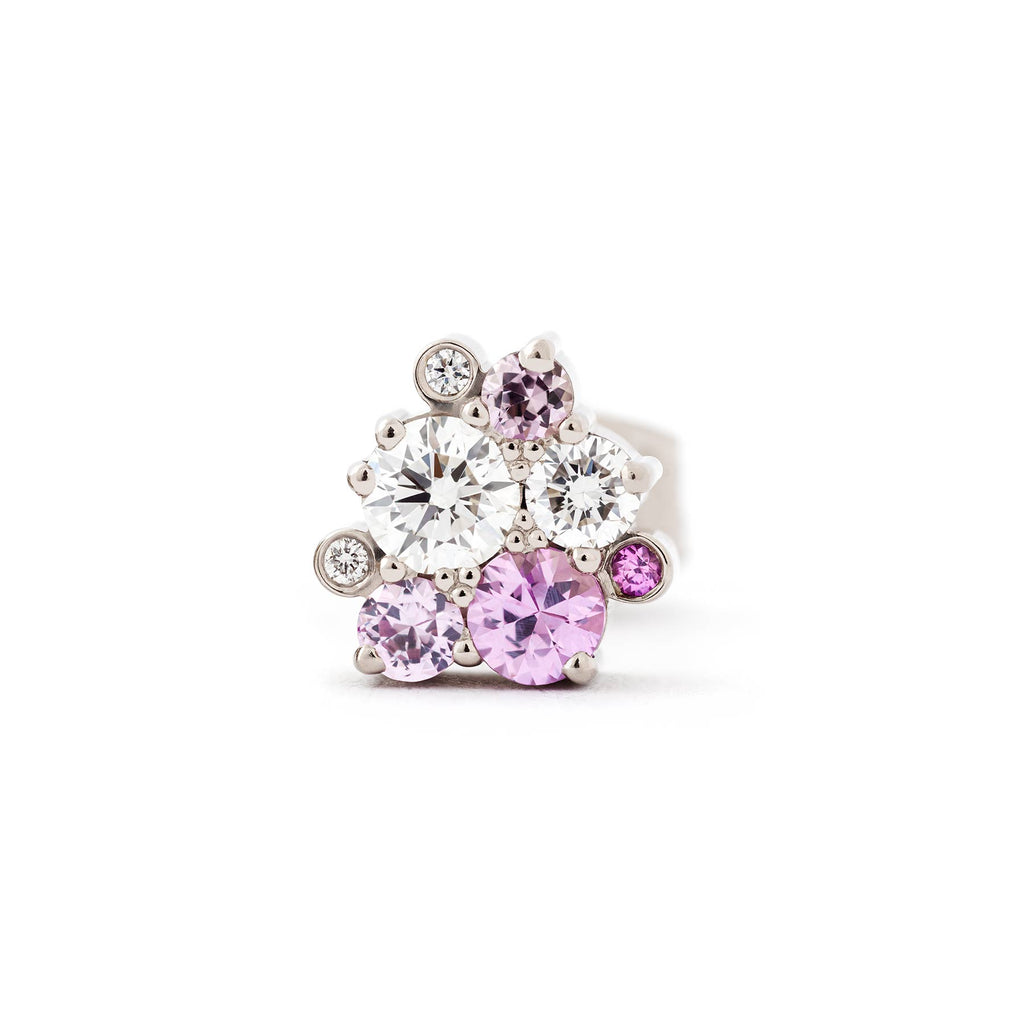 Stud earring with different size pink sapphires and white tw/vs diamond placed asymmetrically in a cluster. Design by Jussi Louesalmi, Au3 Goldsmiths.