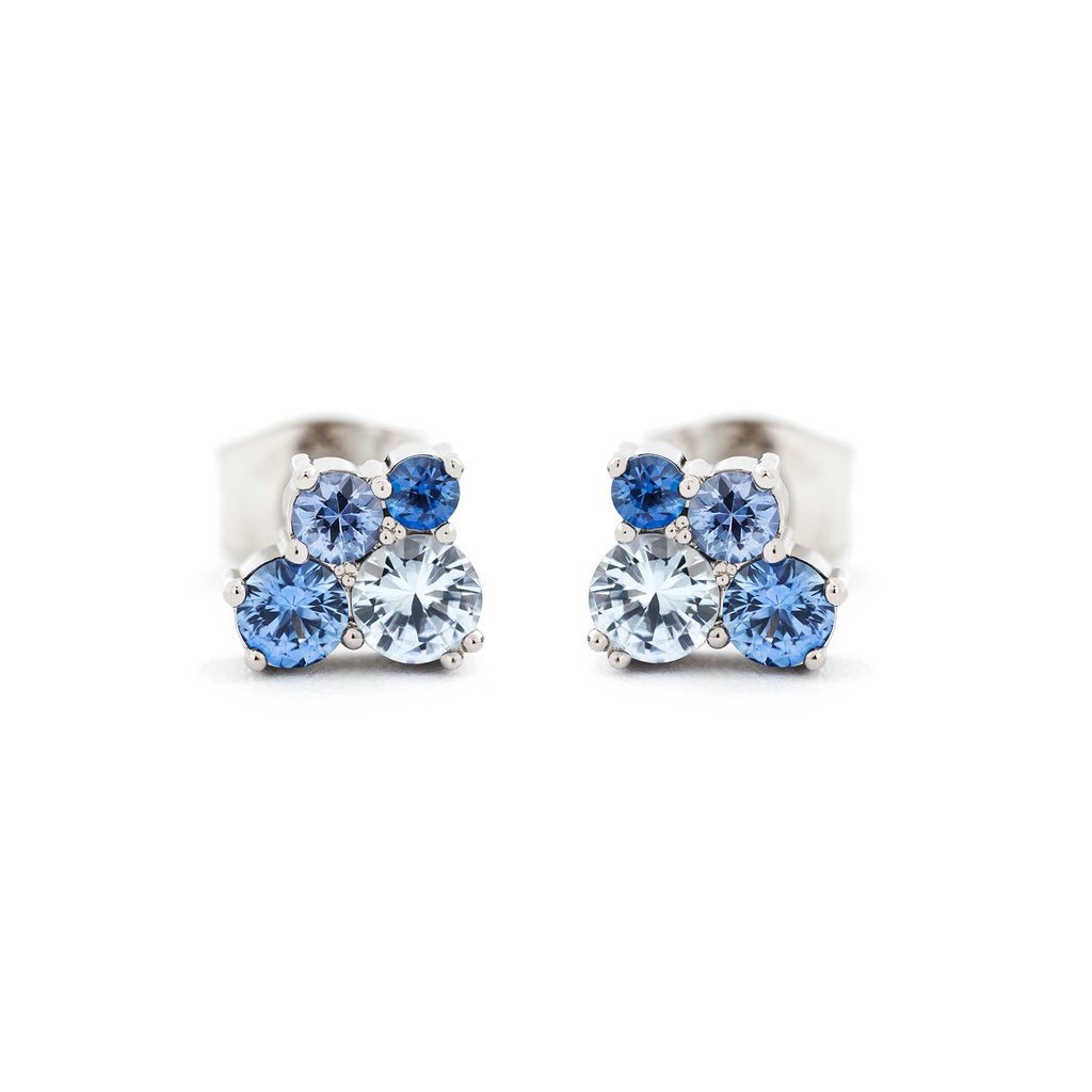 A pair of Keto Meadow studd earrings in 18K white gold with different size blue sapphires. Design by Jussi Louesalmi, Au3 Goldsmiths.