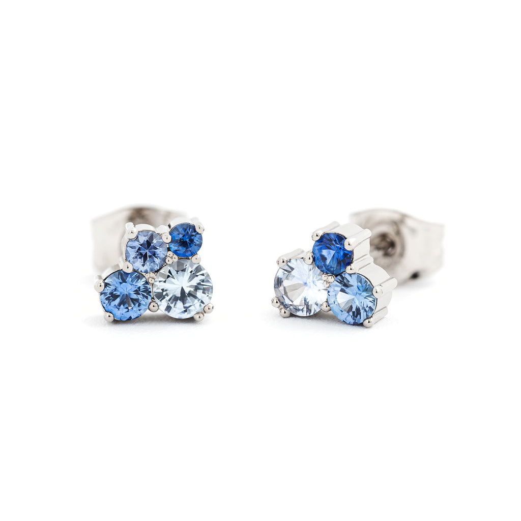 A pair of Keto Meadow studd earrings in 18K white gold with different size blue sapphires. Design by Jussi Louesalmi, Au3 Goldsmiths.