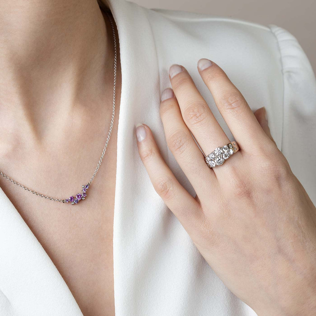 Model wearing a Keto Meadow narrowing ring which has 0.5 carat white diamond and smaller stones. The ring is made in 18K white gold. Design by goldsmith Jussi Louesalmi, Au3 Goldsmiths.