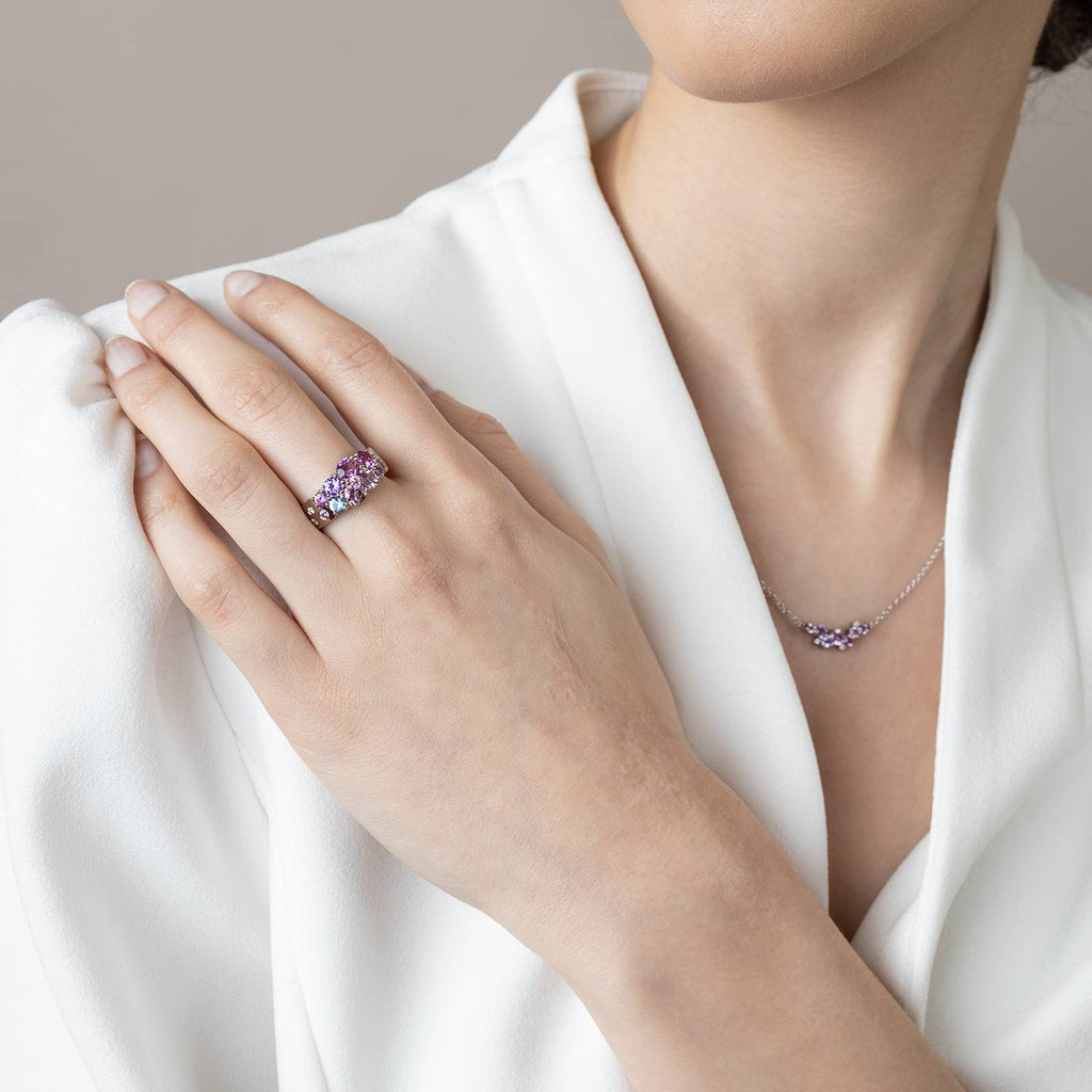 Model wearing a narrowing Keto Meadow 0.5 ring made in 18K white gold with different size pink, violet and blue sapphires and white tw/vs diamonds. Design by Jussi Louesalmi, Au3 Goldsmiths.