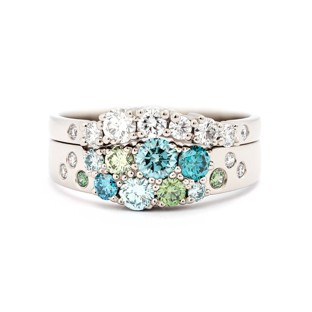 Stacked rings. Narrowing and Arc model rings with turquoise, green and white diamonds from the Keto Meadow collection crafted in 18K white gold. Design by Jussi Louesalmi, Au3 Goldsmiths.