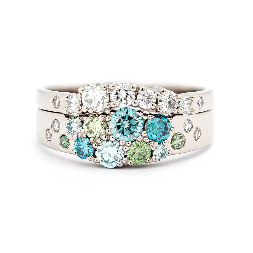 Turquoise and green diamonds with white diamonds in the narrowing Keto Meadow ring model photographed together with Keto MeadoW Arc ring with white diamonds. Both rings made in 18K white gold. Design by Jussi Louesalmi, Au3 Goldsmiths. 