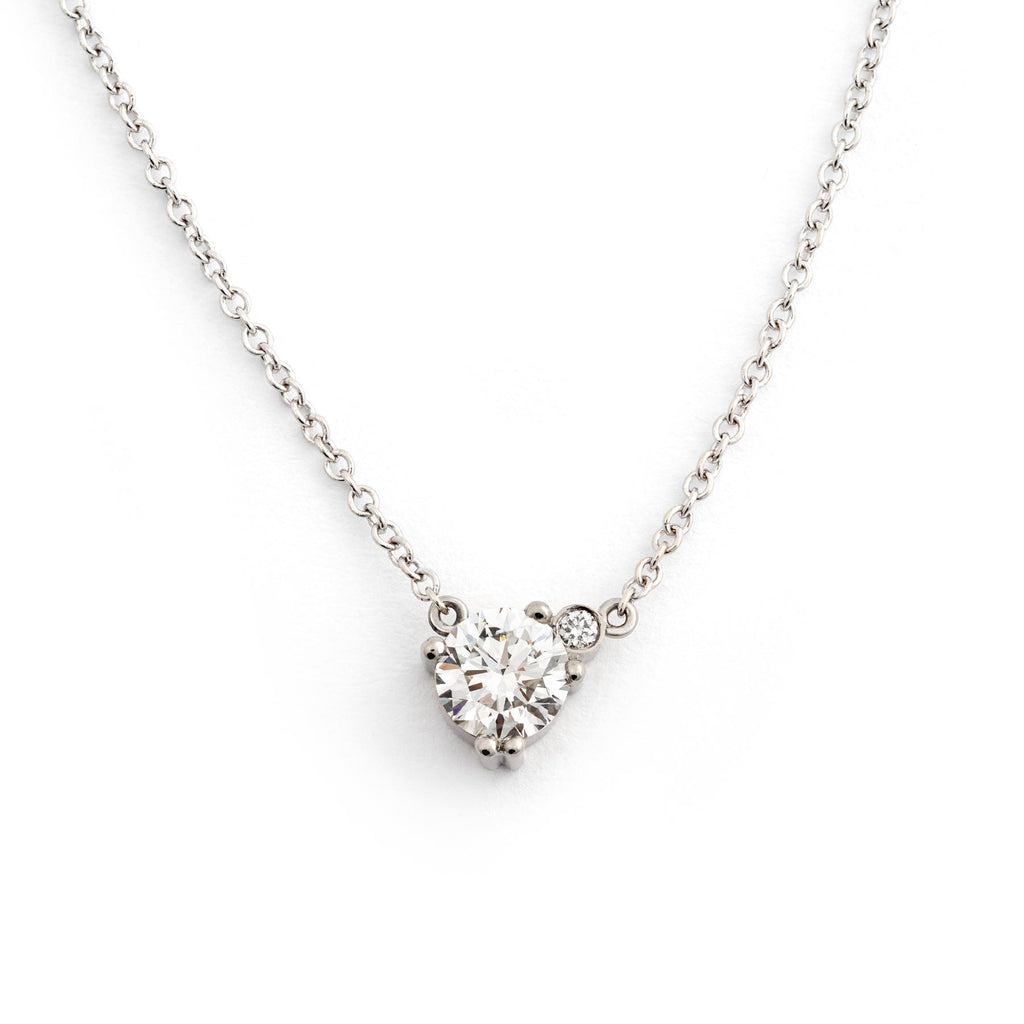 A necklace made in 18K white gold with one larger white diamond and one smaller white diamond in the side. Design Jussi Louesalmi, Au3 Goldsmiths.