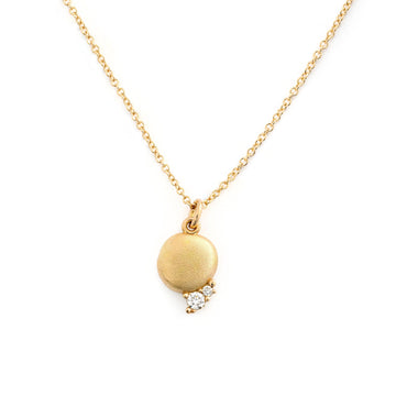 18K golden necklace with a round shape drop of gold in the middle, and two different size white diamonds on the side. Design by Tero Hannonen, Au3 Goldsmiths.