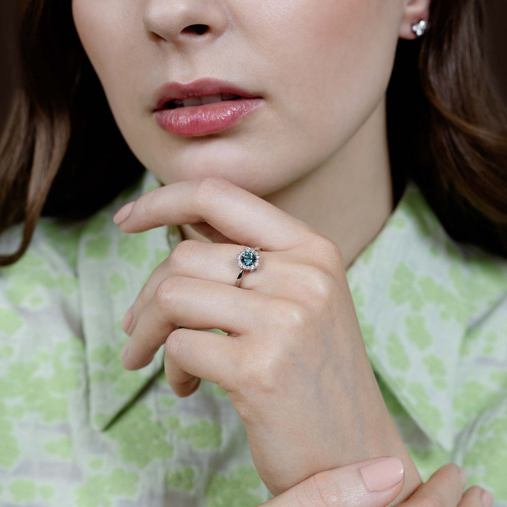 Model wearing a Lilibet diamond ring with Montana green sapphire. Design by Jussi Louesalmi, Au3 Goldsmiths
