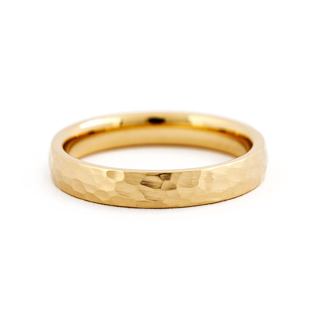 Hammered surface on a 4mm wide ring made in 18K yellow gold, design by Jussi Louesalmi, Au3 Goldsmiths.